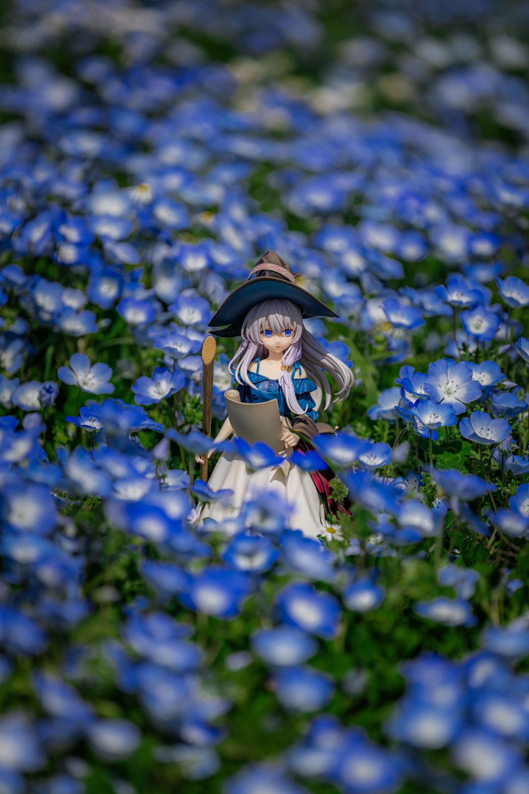 Figure among blue flowers