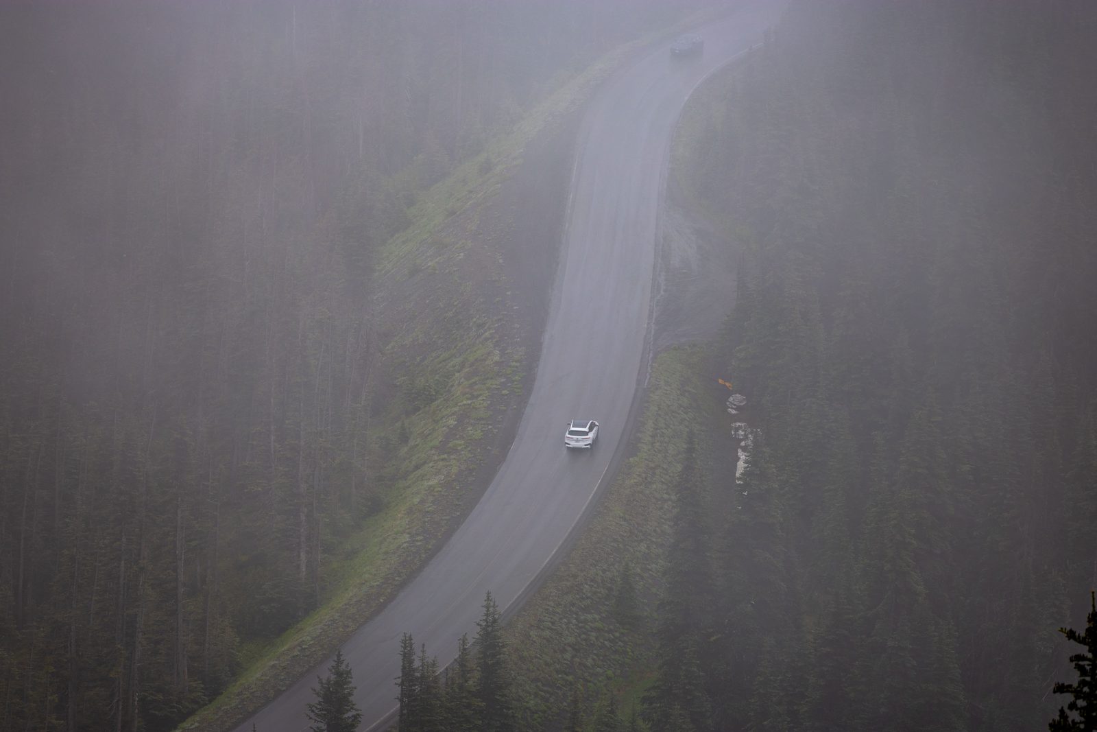 Winding mountain road in fog