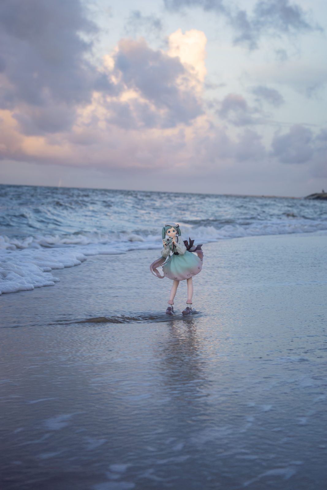 Figure in ocean surf at sunset