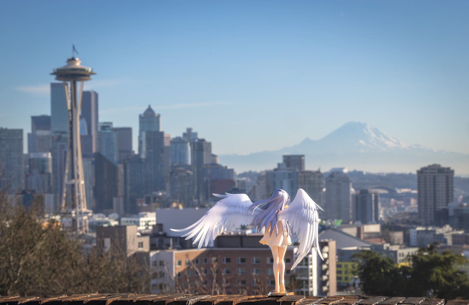 Winged figure with Seattle skyline